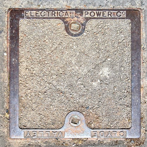A manhole cover with the wording Clyde Valley Electrical Power Company on it.