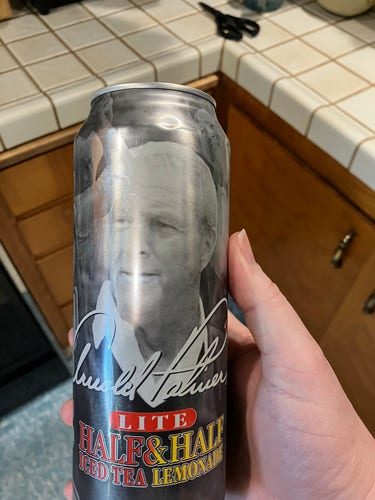 A larger can of thin metal w/ a haunting image of Arnold Palmer on it. It’s a premixed ,lite, Arizona tea. 