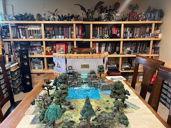 My gaming room table, with a mix of Dwarven Forge trees, waterfall, and mountains, Dungeon Tiles, and more. 