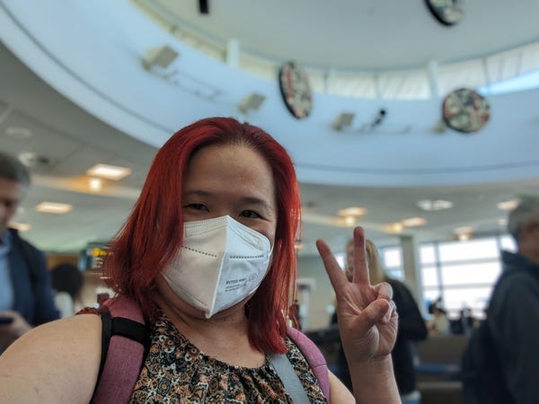 Mariatta selfie inside YVR airport. Red haired woman with a white kn95 mask