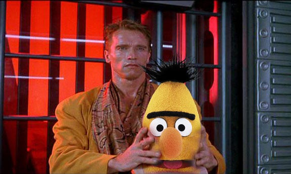 Arnie in total recall holding a Muppet head