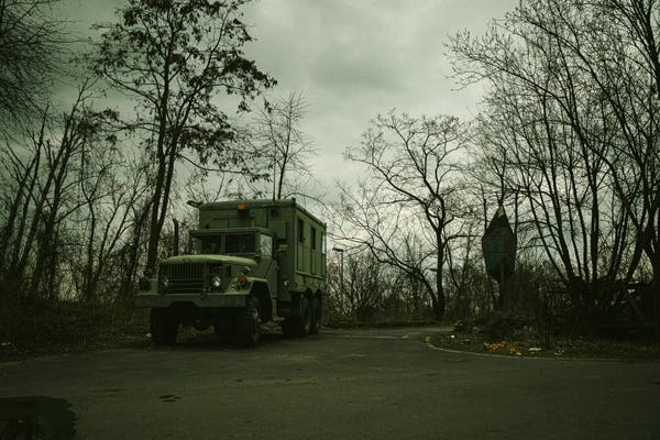 photo of an old army truck in an seemingly abandoned environment, looking creepy with cloudy lighting, greenish tone mapping