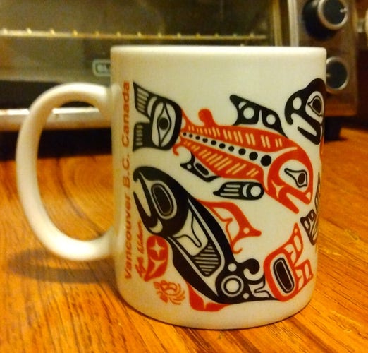 Coffee mug decorated with Haida fish art