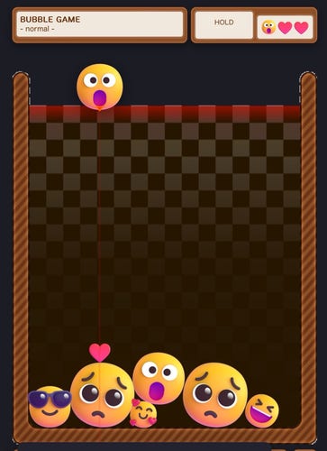 A screenshot of a bubble shooter game with emoji-themed bubbles, indicating 'normal' difficulty, with various emoji faces such as heart eyes and sad expressions.