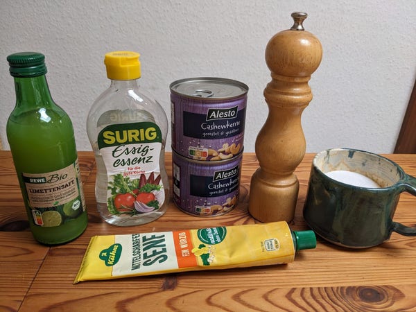 The mentioned ingredients lined up on a table. They're labelled in German.