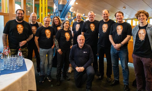 A picture of me in a dark blue ESA fleece kneeling in front of a row of my science & communications colleagues at ESA, all wearing black t-shirts with the same portrait photo of me on. Mad, lovely people.

From left to right: Matt Taylor, Johannes Benkhoff, Olivier Witasse, Anja Appelt, Kate Isaak, Erik Kuulkers, Paul McNamara, Oliver Jennrich, Carl Walker, & Sam Pearson.