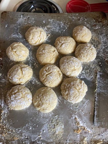 Lemon crinkle cookies on a baking sheet.