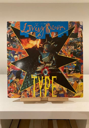 12” single cover for Living Colour’s Type with a vibrant collage of images and the title "Type" in bold, yellow font, displayed on a wooden stand.