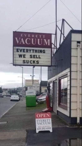 (Sign on a building)  EVERETT VACUUM -  EVERYTHING WE SELL SUCKS