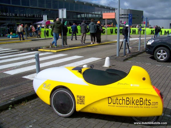Velomobile parked at the airport for an extinction rebellion protest