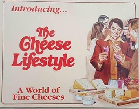 The cover of a vintage pamphlet titled "Introducing The Cheese Lifestyle". It has an illustration of a party with a table spread of various cheeses. Two men are holding wine glasses and presumably discussing cheese.