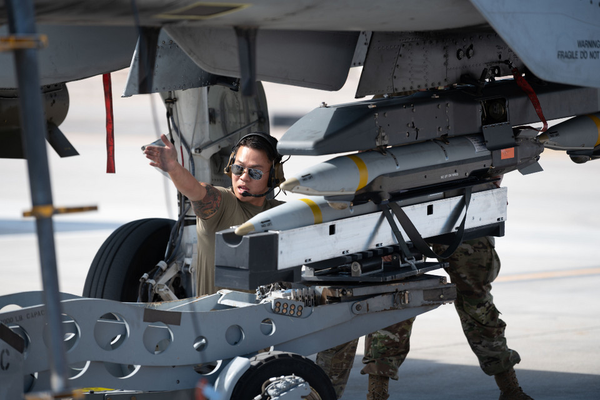 A weapons team crew chief of the 57th Wing Maintenance Group loads GBU-39 small diameter bombs onto an A-10C Thunderbolt II at Nellis Air Force Base, Nevada, on Oct. 24, 2023: