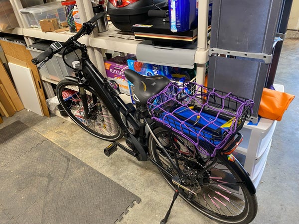 my black bike with purple and violet highlights cleaned up and in garage on kickstand