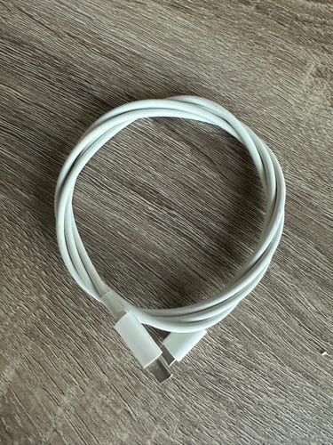 A usb c to usb c cable wrapped around itself in a circle.
