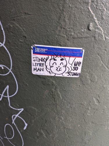 USPS sticker with a drawing of a stinky man