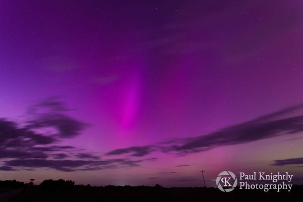 Curtains of purple aurora seen here at twilight over a field in southeast Kansas.