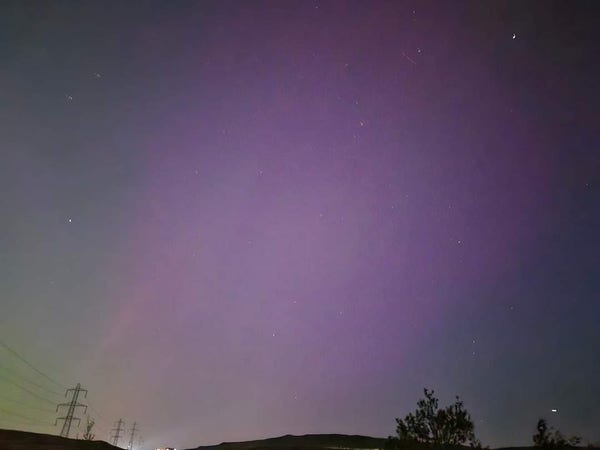 A photo of the sky in northern england, you can see some of the northern lights. Mainly a purpley pink