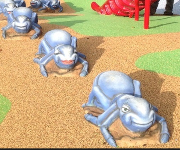 Creatures that are probably meant to be ants walking ominously towards you in a line. They have uncanny human faces and vertebrate like eyes. One has a smug grin another red kissy lips. They are blue and oddly fleshy with ... wrinkles. 