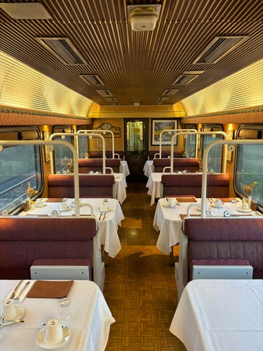 Dining car interior, gleaming in the morning light.