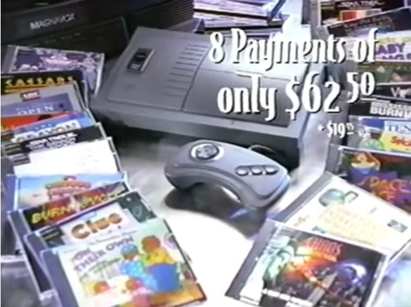 a philips cd-i and joypad is laying inbetween many software cd cases. text: 8 payments of only 62.50 (and in small print): +$19.95