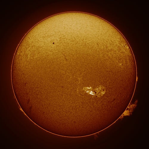Full-disk image of the sun's surface with a large bright spot apparent