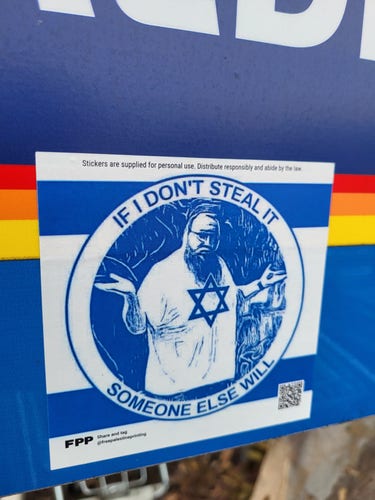 Sticker showing a guy in Jewish skullcap with a star of david t-shirt, shrugging. Caption "If I don't steal it someone else will". Sticker has 2 horizontal blue lines in the manner of an Israeli flag.
