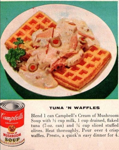 Liquad Tuna with olives is poured over two waffles. 