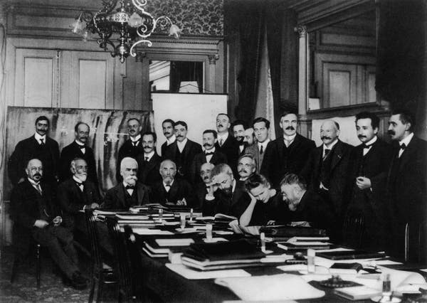 Photograph of participants of the first Solvay Conference, in 1911, Brussels, Belgium. Seated (L-R): Walther Nernst, Hendrik Lorentz, Ernest Solvay (he wasn't present when the above group photo was taken; his portrait was crudely pasted on before the picture was released), Marcel Brillouin, Emil Warburg, Jean Baptiste Perrin, Wilhelm Wien, Marie Skłodowska-Curie, and Henri Poincaré. Standing (L-R): Robert Goldschmidt, Max Planck, Heinrich Rubens, Arnold Sommerfeld, Frederick Lindemann, Maurice de Broglie, Martin Knudsen, Friedrich Hasenöhrl, Georges Hostelet, Edouard Herzen, James Hopwood Jeans, Ernest Rutherford, Heike Kamerlingh Onnes, Albert Einstein, and Paul Langevin.