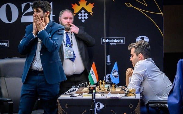Vidit holds his hands in front of his face and cannot believe what has happened. Nepomniachtchi is sitting on the board, looking confident (Photo: FIDE / Michal Walusza)
