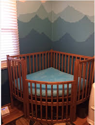 specialty baby crib designed to fit in the corner of the room