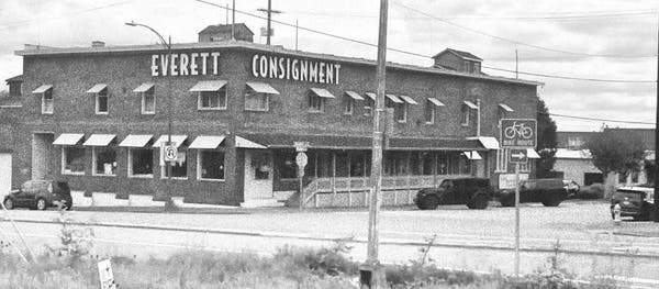 A photo of Everett Consignment in grayscale. I made it grayscale because somehow I associate the idea of consignment stores with grayscale. 

It's a brick building located on a corner in Everett, Washington.