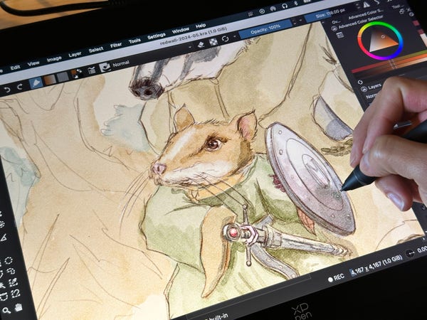 Snapshot of me drawing on my XP Pen tablet, my watercolor illustration in Krita on the screen.