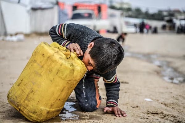 A child drinks water from a dirty plastic container in Rafah on 19 February.

Photograph: Abed Zagout/Anadolu via Getty Images