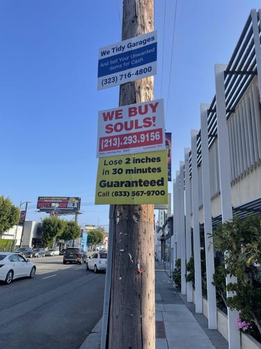 Sign on pole "WE BUY SOULS" along with phone number