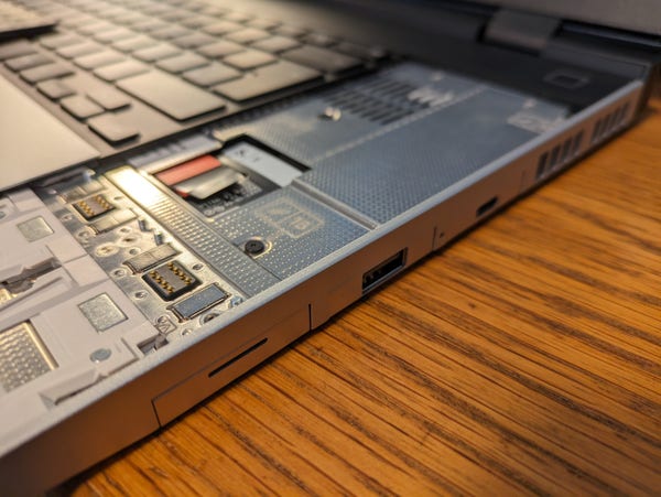 Close-up picture of the right-hand edge of a Framework 16 laptop with the numeric keypad removed, showing how the three expansion slots in the side of the laptop are located underneath a solid sheet of metal.