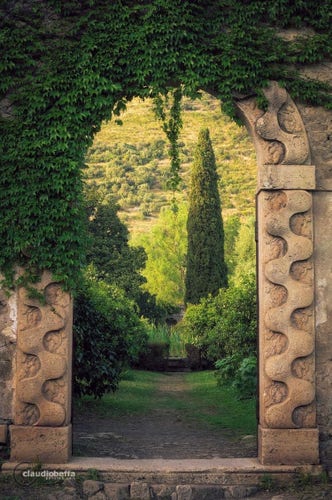 Looking into a garden through an arched entrance. What in there? Your lost car keys? The key to life itself? Who knows? It's green and lush, though. Now that you've asked it, you just realize your car keys are gone.