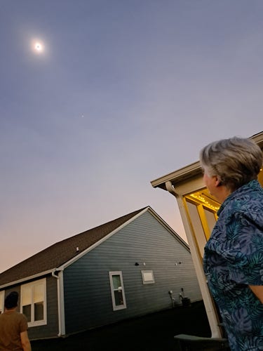 Two friends looking up at a ring of fire eclipse