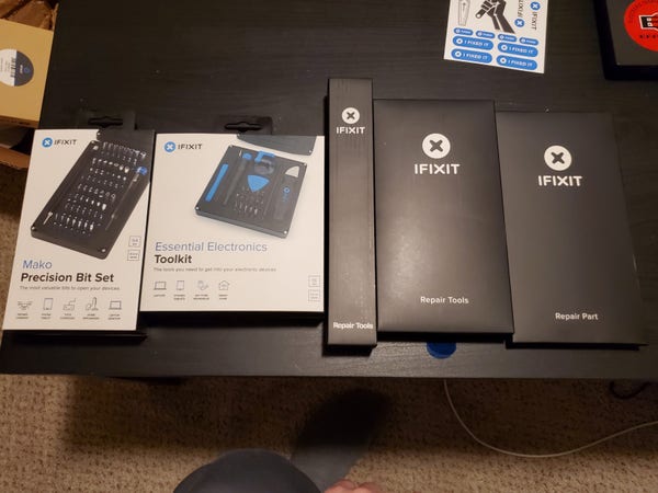 Various product boxes from iFixit on a table