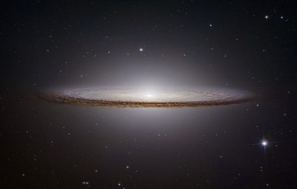 M104 (aka Messier 104, NGC 4594, and the Sombrero Galaxy) is a fantastic spiral galaxy which is famous for its nearly edge-on profile featuring a broad ring of obscuring dust lanes. Seen here in silhouette against an extensive central bulge of stars, the swath of cosmic dust lends a broad brimmed hat-like appearance to the galaxy suggesting its more popular moniker, the Sombrero Galaxy. 