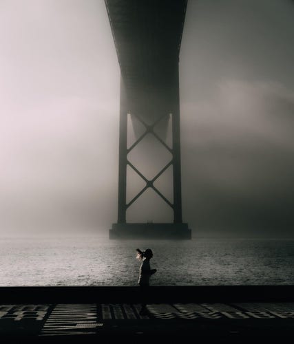 Foggy morning scene under the bridge in Lesbon Portugal 