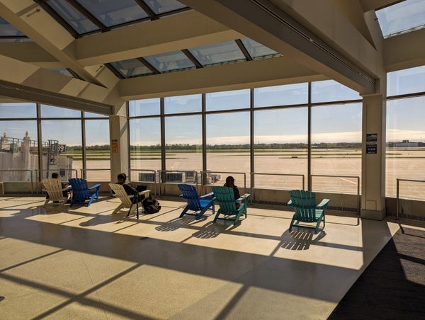 Seating area with lawn chairs overlooking the airport