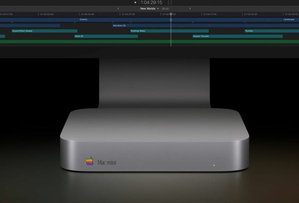A photo of a current aluminium bodied Mac mini, with a diamond cut rainbow apple logo embedded in the lower left corner of the front case, with Apple Garamond text stating clearly just "Mac mini"
