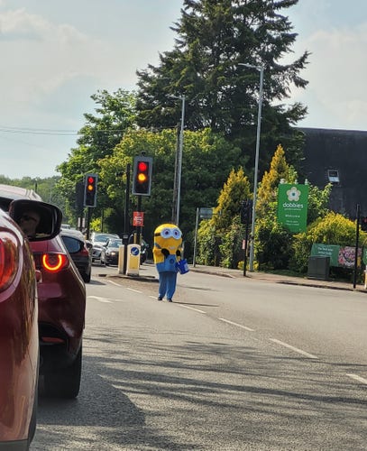 Minion in the road. I repeat. Minion. In. The. Road. It's a small yellow penis looking mf'er with big googly eyes, wearing dungarees. What is happening. 