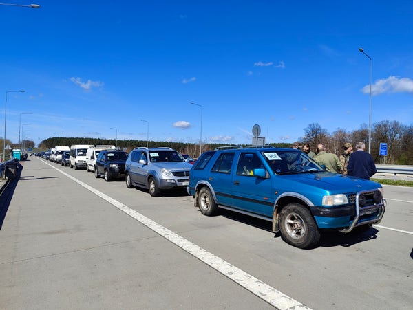 Cars waiting in line at the border. Mostly off-road vehicles.