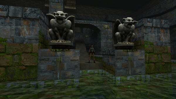 Lara standing in between two gargoyles.