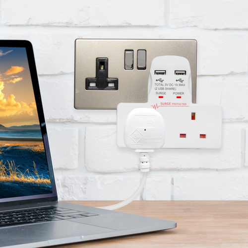 Product photo. A small white unit is plugged into a wall socket. The unit has two UK sockets and two USB sockets.