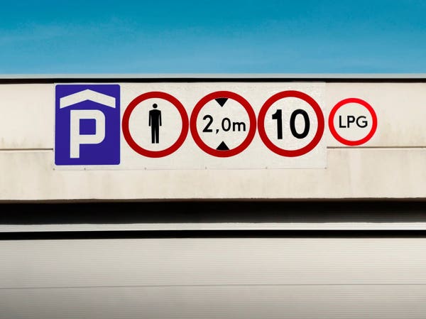 Traffic signs on a wall above an underground parking, starting from the left:

1. Parking space ahead
2. Pedestrians not allowed to walk in
3. No vehicles higher than 2 metres allowed
4. Maximum allowed speed 10 km/h
5. No vehicles using LPG as their fuel