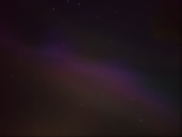 A feint purple aurora in the sky.