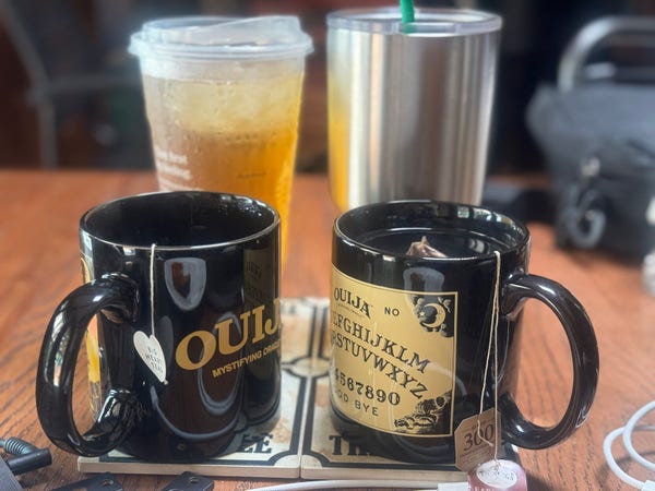 Half-consumed mug of hot chai, mug of earl grey that is double-bagged, Starbucks green tea from the early morning run with the dog for a pup cup, and a Yeti tumbler full of room temperature regular tea with a hint of Constant Comment, all on their own coasters that say “Don’t fuck up the table.”