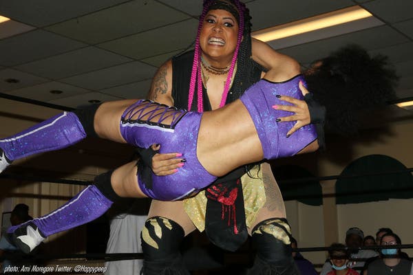 Nyla Rose carrying an opponent in her arms